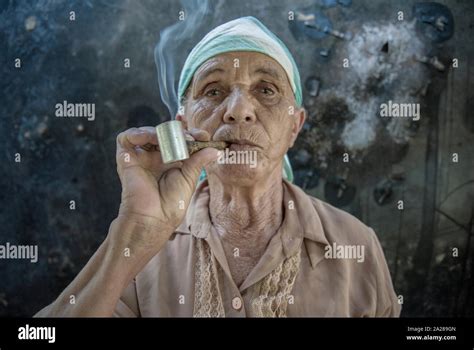 Old woman smoking pipe hi-res stock photography and images - Alamy