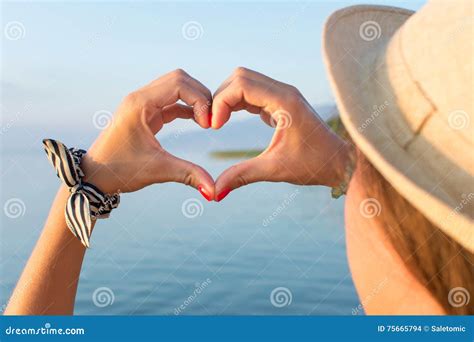 Woman Hands Making Heart Shape at the Beach Stock Photo - Image of background, back: 75665794