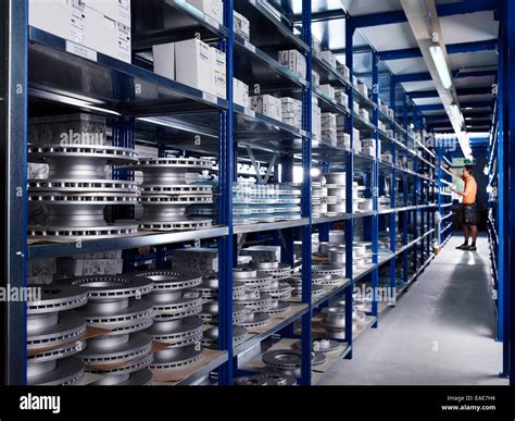 Warehouseman working in the spare parts storage section of a car repair ...