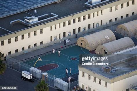 Inmates gather outside of tents at the Federal Correctional Institute... News Photo - Getty Images