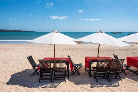 Red wooden dining table with white umbrella on the beach 7304787 Stock ...