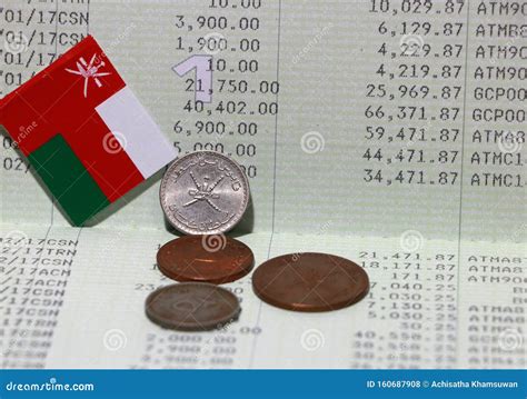 Four Coins of Rial Omani Money with Mini Oman Flag on the Book Bank ...