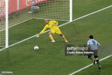 Luis Suarez of Uruguay scores the opening goal past Oscar Perez of ...