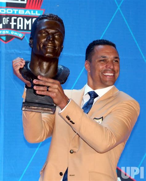 Photo: Tony Gonzales with his bust at the Pro Football Hall of Fame ...