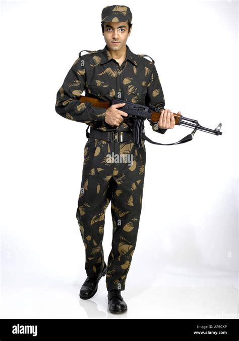 Indian army soldier with AK-47 gun and walking Stock Photo - Alamy