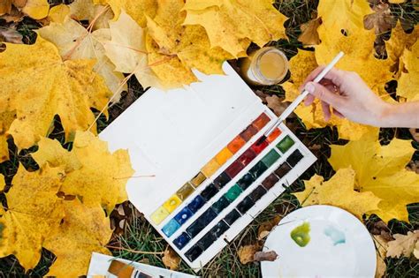 Premium Photo | Artist's hand with a palette of colors on of leaves