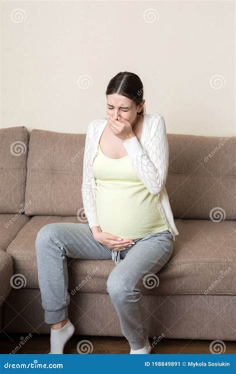 Pregnancy Morning Sickness. Pregnant Woman Having Nausea Feeling Bad in Sofa at the Home Stock ...