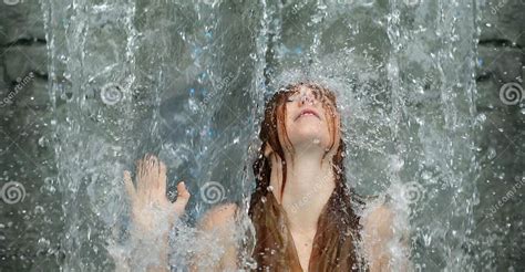 Beautiful Young Cute Portrait of a Redhead Woman with Raised Arm Under the Splashing Pattering ...