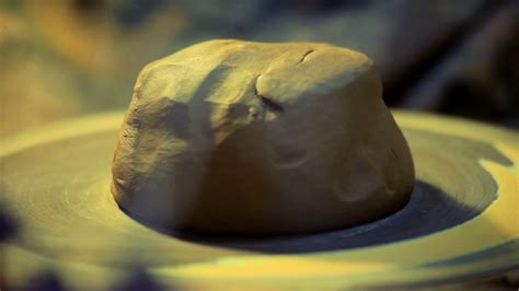 Men hands work piece clay on potters wheel. Traditional process making ...