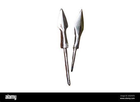 Making medieval arrows for bow shooting, isolated on a white background. Reconstruction of the ...