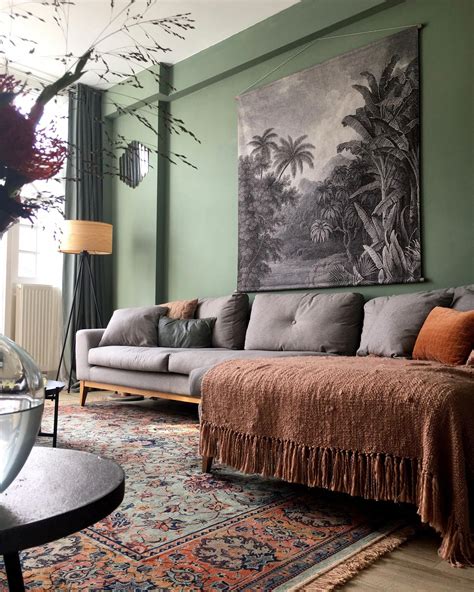 Gray tapestry over a gray sofa, green walls & a beautiful green & clay patterned rug # ...