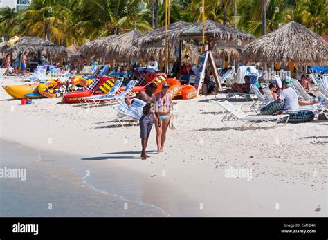 People walking and chatting on the well known Palm Beach in Aruba Stock ...