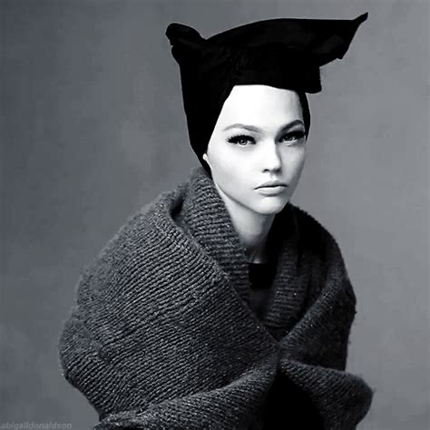 a black and white photo of a mannequin with a scarf around her neck