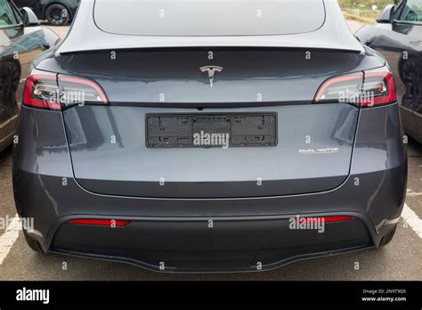 Tesla Electric vehicle EV cars waiting at a delivery collection car hub ...