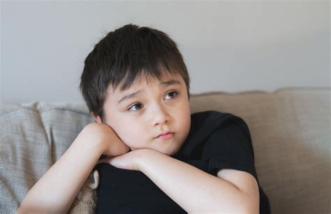 Premium Photo | Portrait young boy looking deep in thought school kid ...