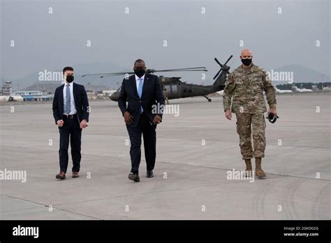 Secretary of Defense Lloyd J. Austin III walks with the commander of ...