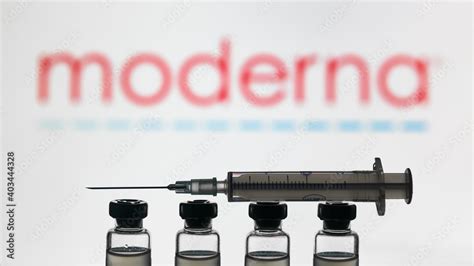 Moderna COVID-19 vaccine concept, syringe and bottles on logo ...