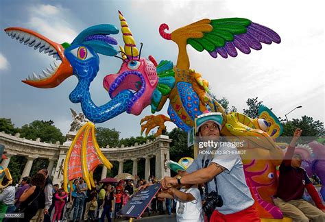 A man pushes a traditional 'Alebrije' during the third parade of "The... News Photo - Getty Images