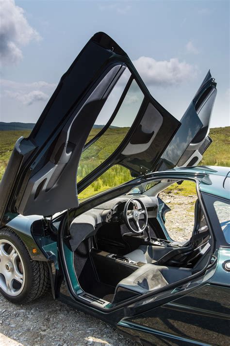 a car with its doors open sitting on the side of a road