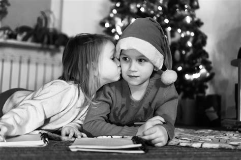 Premium Photo | Boy in a red cap writes a letter to santa