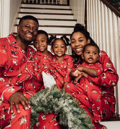 "Family Taking Christmas Pictures On The Stairs In Matching Pajamas" by ...