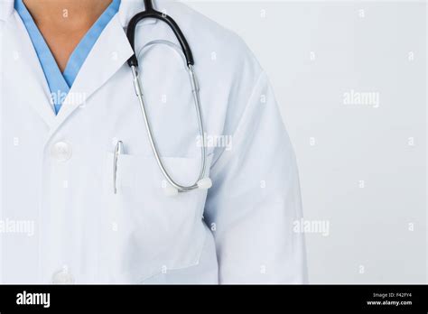 Doctor standing with stethoscope Stock Photo - Alamy