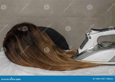 Young Beautiful Girl Ironing Her Hair on an Ironing Board Stock Photo ...