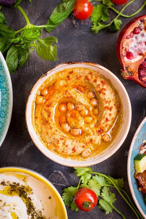 Table served with middle eastern vegetarian dishes. Hummus, tahi Stock Photo by ©somegirl 80053074