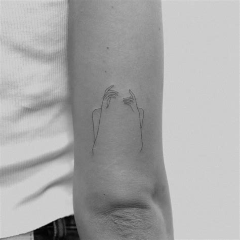 Abstract woman’s silhouette tattoo done in fine line.