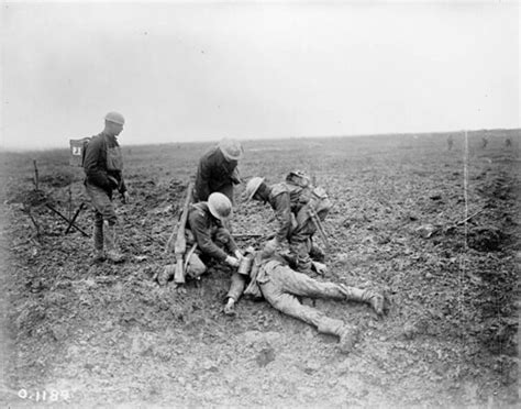 Soldiers treating a wounded German on the battlefield at V… | Flickr