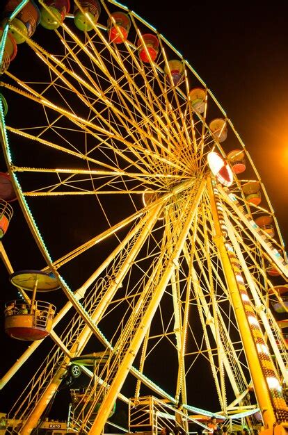 Premium Photo | Ferris wheel at fairground at night