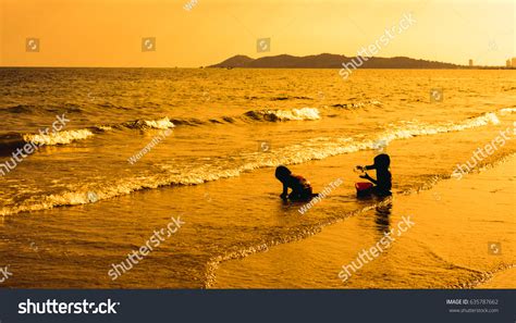 Silhouette Children Playing On Beach Against Stock Photo 635787662 ...