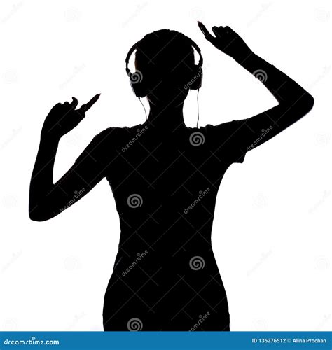 Silhouette of a Happy Girl Listening To Music in Headphones, Figure of Young Woman with Hands Up ...