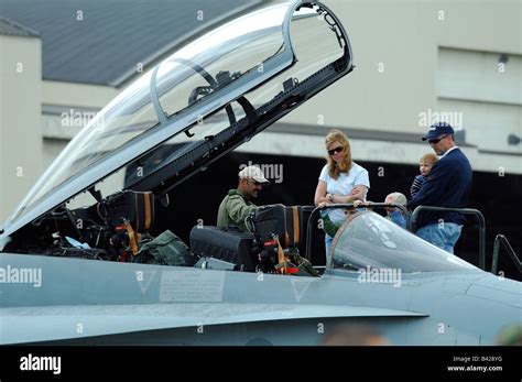 American jet fighter F-18 Hornet cockpit with pilot and american family, Anchorage air show ...