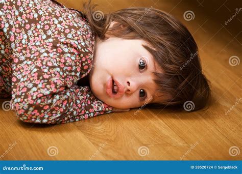 Little girl lying on floor stock photo. Image of girl - 28520724