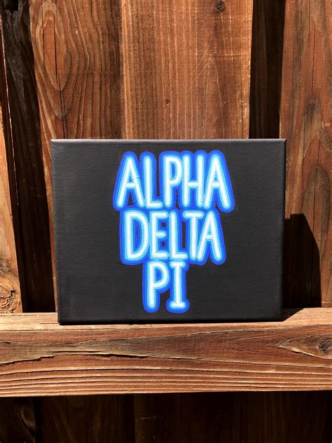 a sign that says,'alpha delta pt'on the side of a wooden bench