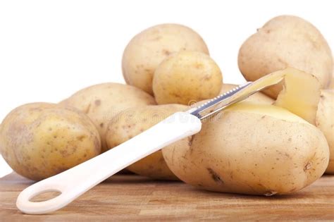 Peeling potatoes stock photo. Image of golden, fresh - 19866632