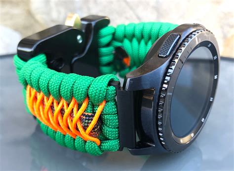 a green and orange bracelet with a camera lens attached to the ...