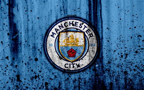 the manchester city logo is shown on an old blue metal surface with ...