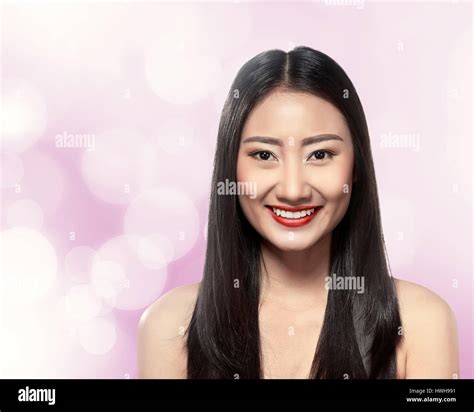 Beautiful asian woman over blur background Stock Photo - Alamy