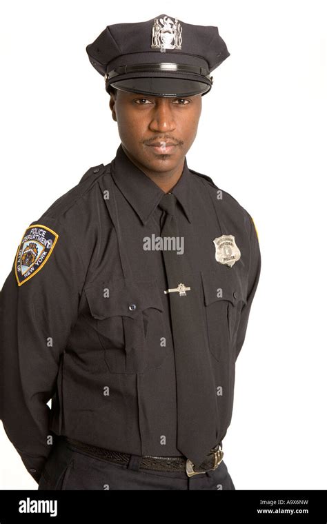 Young African American police officer in uniform stands with his hands ...