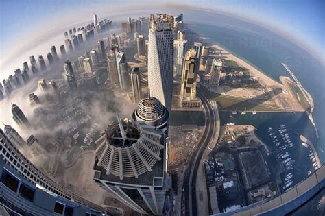 Aerial view of cityscape with skyscrapers above the clouds in Dubai ...