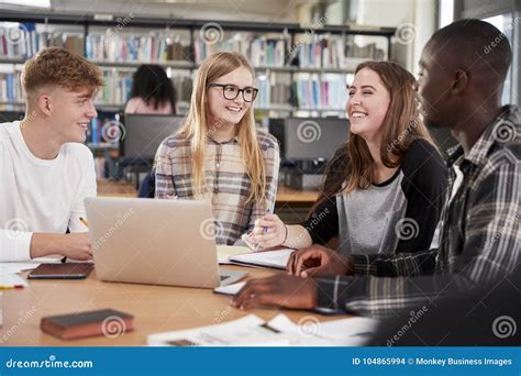 Group of College Students Collaborating on Project in Library Stock Photo - Image of indoors ...