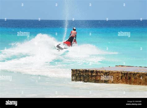 Jet ski on ocean waters. A jet skier races out from shore Stock Photo ...