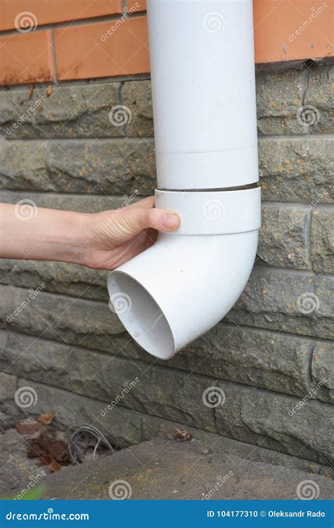 Installing Rain Gutter Downpipe. Contractor Hands Repair Rain Gutter Downspout Pipe Stock Photo ...