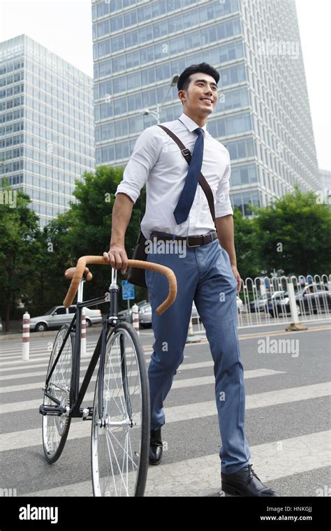 Young men go to work by bike Stock Photo - Alamy