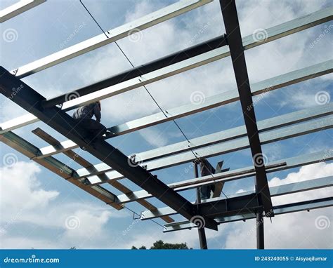 Construction Workers Installing Metal Roof Trusses at the Construction Site. Editorial Image ...