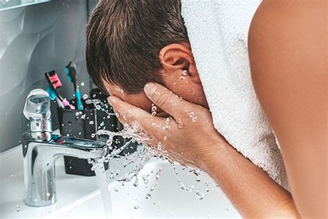 A man washes his face with clean water. The concept of personal hygiene - Creative Commons Bilder