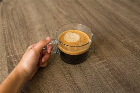 Close Up of a Hand Holding a Clear Coffee Mug with a Hot Coffee ...