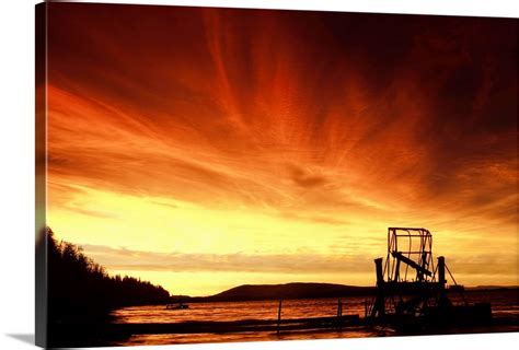 A fish wheel spins during sunrise on the Tanana River near the village of Tanana, Alaska Wall ...